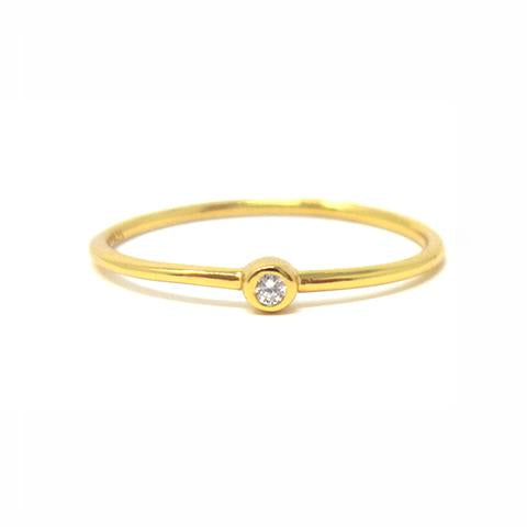 Yellow gold solitaire bezel ring with cubic zirconia